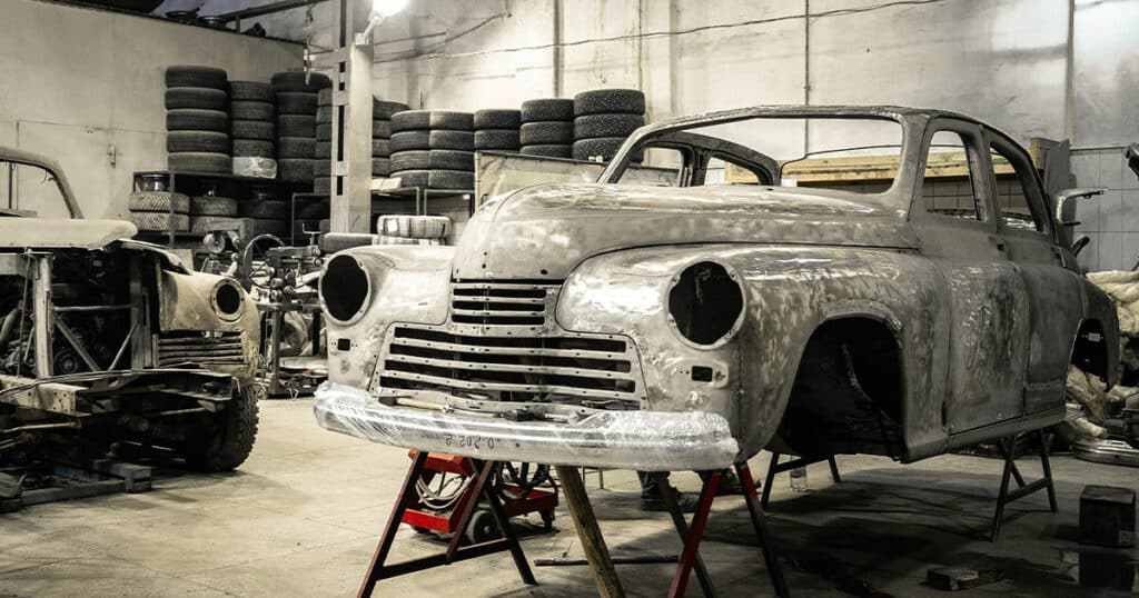Classic Car Restoration with car disassembled and parts labeled