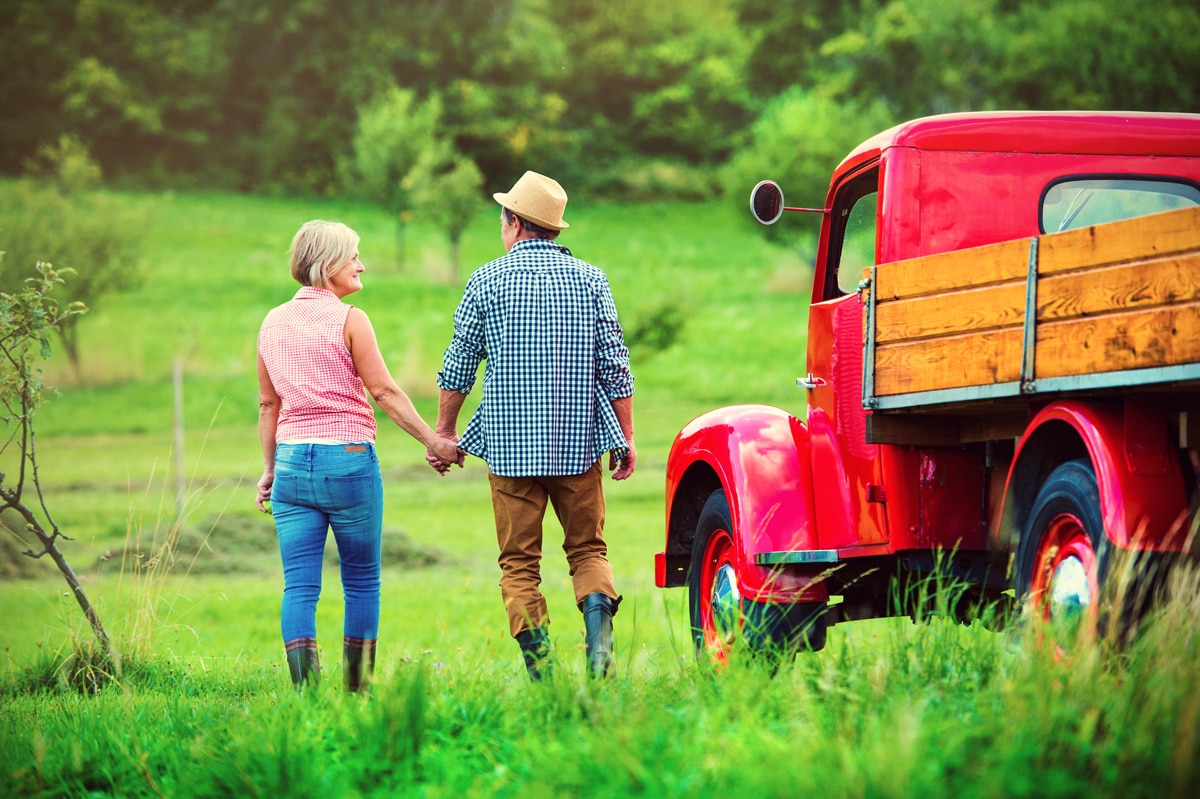 Couple with an Old Red Ford Truck Converted to 4WD for tasks around their property